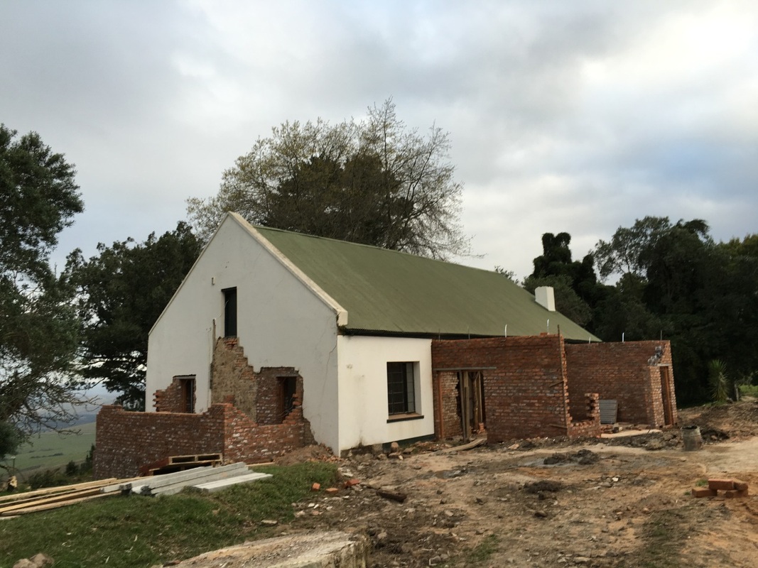 The farm house undergoing construction to expand on the original structure 